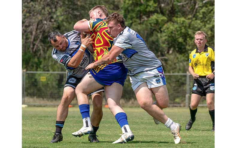 Logan Marshall and Jake Humphrey wrap up Josh Jamieson. Photo: Kim Ambrose/SaltyFoxFotography.