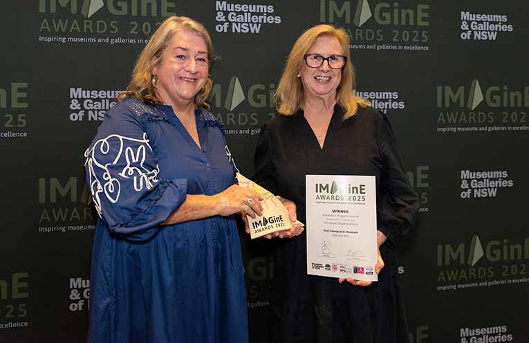 Colleen Fitzgerald presents Port Macquarie Museum Curator Debbie Sommers with a 2025 IMAGinE Award. Photo: Garry Trinh.