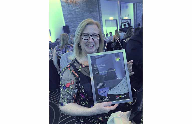 Port Macquarie Museum Curator Debbie Sommers with the 2025 NSW Tourism Awards Silver certificate.