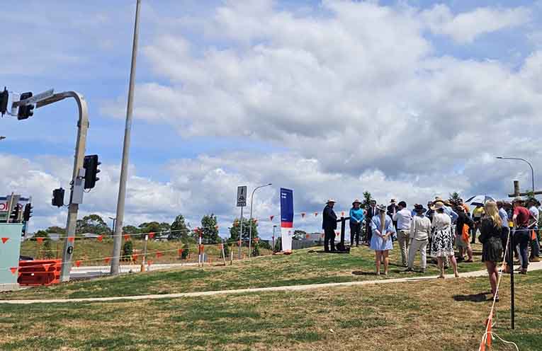 Regional Roads Minister Jenny Aitchison (in blue), Mayor Adam Roberts (l) and Port Macquarie MP Rob Dwyer (r) on Wednesday, near the new Matthew Flinders Drive traffic lights. Photo: David Heffernan.