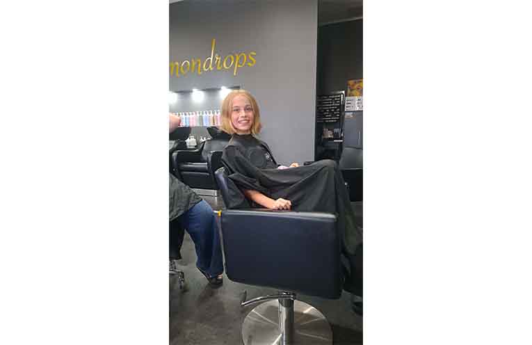 Matilda in the chair after cutting her hair. Photo: supplied.