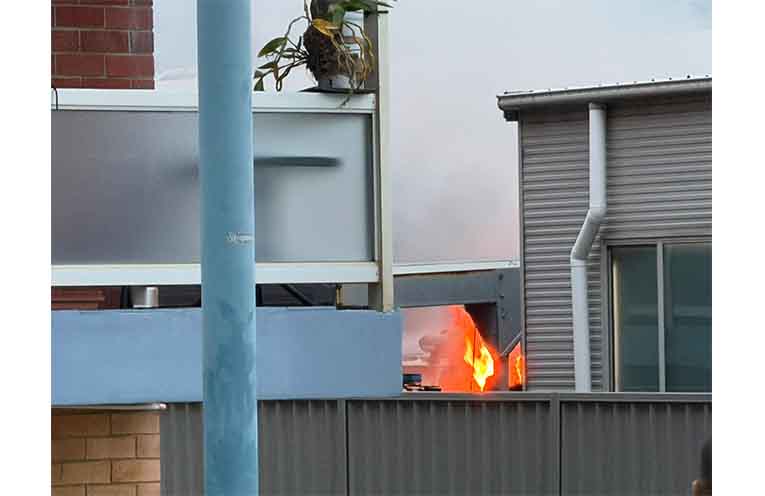 Flames and smoke can be seen from behind the station’s fence. Photos: supplied.