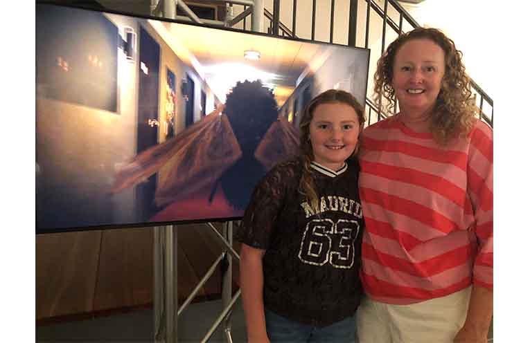 MacKillop College HSC Visual Arts Teacher Loretta North and her daughter Grace with Charlie Penn’s 3D animation, ‘Eye of the Moth.’ Photo: Pauline Cain.