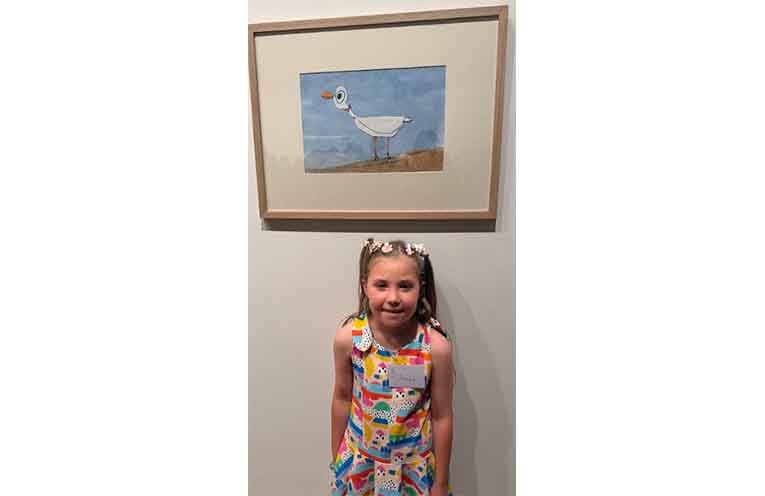 Penny Bouwer, a kindergarten student from Port Macquarie Public School, with her artwork, “Chip the Seagull”.