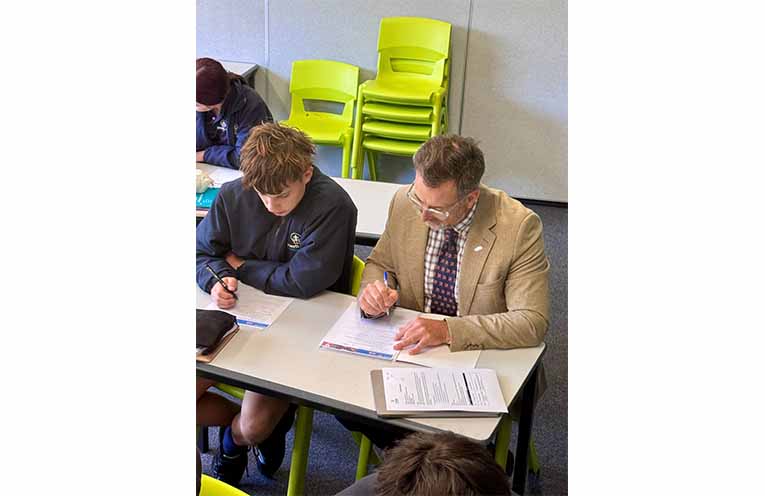 Mr Cohen and his classmate working.